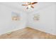 Neutral bedroom with hardwood floors, two windows and a ceiling fan at 121 Alexis Forest Dr, Stanley, NC 28164