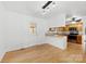 Bright dining room with open view of the kitchen featuring hardwood floors at 121 Alexis Forest Dr, Stanley, NC 28164