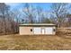 Exterior of a large two-door metal garage building surrounded by mature trees at 121 Alexis Forest Dr, Stanley, NC 28164