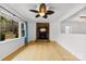 Bright living room with brick fireplace, large windows and a ceiling fan at 121 Alexis Forest Dr, Stanley, NC 28164