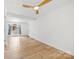 Bright living area featuring hardwood floors, a modern ceiling fan, and ample natural light at 121 Alexis Forest Dr, Stanley, NC 28164