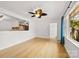 Living room with open view of the kitchen featuring hardwood floors and a ceiling fan at 121 Alexis Forest Dr, Stanley, NC 28164