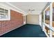 The spacious screened porch features a ceiling fan and brick accents at 121 Alexis Forest Dr, Stanley, NC 28164