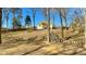 Spacious backyard featuring a charming wooden bridge leading to the home at 12508 Asbury Chapel Rd, Huntersville, NC 28078