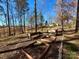 View of backyard with raised garden beds and a charming bench, perfect for enjoying nature at 12508 Asbury Chapel Rd, Huntersville, NC 28078