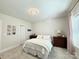 A cozy bedroom featuring a queen-size bed, neutral walls, and dark wood furnishings at 12508 Asbury Chapel Rd, Huntersville, NC 28078