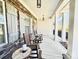 Inviting covered front porch with stone accents, rocking chairs, and stylish lighting, perfect for relaxation at 12508 Asbury Chapel Rd, Huntersville, NC 28078