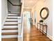 Entryway with hardwood floors leading to staircase, decorated with tasteful decor at 12508 Asbury Chapel Rd, Huntersville, NC 28078