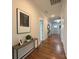 Inviting hallway features hardwood floors, tasteful decor, and ample natural light at 12508 Asbury Chapel Rd, Huntersville, NC 28078