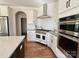 Modern kitchen features stainless steel appliances, a stylish range hood, and white cabinetry at 12508 Asbury Chapel Rd, Huntersville, NC 28078