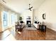 Open living area with hardwood floors, a cozy fireplace, and lots of natural light at 12508 Asbury Chapel Rd, Huntersville, NC 28078