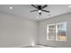 Bedroom features wood-look flooring, neutral walls, a ceiling fan, and natural light at 127 Mills Garden Rd, Statesville, NC 28625