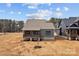 Rear exterior of the home featuring a screened-in porch and ample backyard space at 127 Mills Garden Rd, Statesville, NC 28625