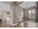 Dining area with wood floors, neutral paint, a modern chandelier, and views of the backyard at 131 Chimney Rock Ct, Denver, NC 28037