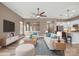 A spacious living room with wood flooring, ceiling fan, comfortable furniture, and modern decor at 131 Chimney Rock Ct, Denver, NC 28037