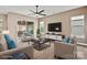 Cozy staged living room featuring neutral tones, plush seating, and an adjacent screened patio at 131 Chimney Rock Ct, Denver, NC 28037