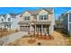 Charming two-story home showcasing neutral siding, a two-car garage, and manicured landscaping at 13729 Roderick Dr # 188, Huntersville, NC 28078