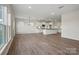 Bright, open-concept living space with wood floors flowing into a modern kitchen at 13729 Roderick Dr # 188, Huntersville, NC 28078