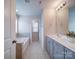 Bathroom featuring double sink vanity and separate tub and shower at 15040 Cordelia Dr, Charlotte, NC 28278