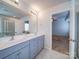 Bathroom featuring double sink vanity, tile floor, and large mirror at 15040 Cordelia Dr, Charlotte, NC 28278
