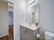 Stylish half bathroom with a modern vanity, a large mirror, and neutral walls at 15040 Cordelia Dr, Charlotte, NC 28278