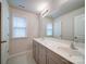 Bright bathroom featuring a double vanity, gray cabinets, and tiled floor at 15040 Cordelia Dr, Charlotte, NC 28278