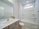 Well-lit bathroom featuring a vanity, tub-shower combo, and neutral walls at 15040 Cordelia Dr, Charlotte, NC 28278