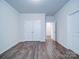 Bedroom with double door closet, hardwood flooring and neutral walls at 15040 Cordelia Dr, Charlotte, NC 28278