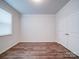 Bedroom featuring a window with blinds, closet with doors, and hardwood flooring at 15040 Cordelia Dr, Charlotte, NC 28278