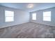 Spacious bedroom with multiple windows providing ample natural light and neutral carpet at 15040 Cordelia Dr, Charlotte, NC 28278