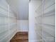Walk-in closet with shelving for storage and hardwood floors at 15040 Cordelia Dr, Charlotte, NC 28278