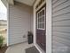 Inviting front door with glass accents, decorative flower pot and neutral colored siding at 15040 Cordelia Dr, Charlotte, NC 28278