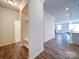 Bright hallway featuring hardwood floors that lead to the kitchen and living area at 15040 Cordelia Dr, Charlotte, NC 28278