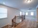 Staircase featuring a railing, carpeted steps, and access to an upper level living space at 15040 Cordelia Dr, Charlotte, NC 28278