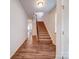 Hallway featuring hardwood flooring, a staircase, and views of the living area at 15040 Cordelia Dr, Charlotte, NC 28278