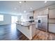 Modern kitchen with granite island, stainless steel appliances, and sleek white cabinets at 15040 Cordelia Dr, Charlotte, NC 28278