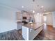 Open concept kitchen featuring granite island, stainless steel appliances, and pendant lighting at 15040 Cordelia Dr, Charlotte, NC 28278