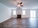 Bright living room featuring a fireplace, ceiling fan, and ample natural light at 15040 Cordelia Dr, Charlotte, NC 28278