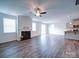 Bright living room featuring a fireplace, ceiling fan, and sliding door access to the outdoors at 15040 Cordelia Dr, Charlotte, NC 28278