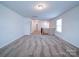 Bright, open loft area with neutral carpet, natural light, and views to the hallway at 15040 Cordelia Dr, Charlotte, NC 28278