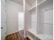 Functional mudroom area equipped with hooks, shelving, and a built-in bench at 15040 Cordelia Dr, Charlotte, NC 28278