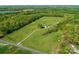 Aerial view of an estate with lush green fields and mature trees at 16160 Hopewell Church Rd, Midland, NC 28107
