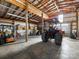 Spacious barn interior with a tractor and other equipment, offering ample storage and workspace at 16160 Hopewell Church Rd, Midland, NC 28107
