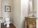 Half bathroom with marble sink and hardwood floors, featuring modern fixtures at 16160 Hopewell Church Rd, Midland, NC 28107