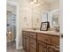 Bathroom featuring a double sink vanity with wood cabinets and a glass-enclosed shower at 16160 Hopewell Church Rd, Midland, NC 28107