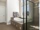 Bathroom featuring a soaking tub, glass-enclosed shower, and tiled floors at 16160 Hopewell Church Rd, Midland, NC 28107
