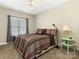 Comfortable bedroom featuring a ceiling fan, neutral walls, and a window with blinds at 16160 Hopewell Church Rd, Midland, NC 28107