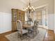 Traditional dining room with hardwood floors, elegant chandelier, and bay window, perfect for hosting at 16160 Hopewell Church Rd, Midland, NC 28107
