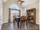 Elegant dining room with tile floors, bright windows, a wooden table and chairs, and a display cabinet at 16160 Hopewell Church Rd, Midland, NC 28107