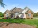 Charming home featuring stone accents, manicured lawn, and lush landscaping at 16160 Hopewell Church Rd, Midland, NC 28107